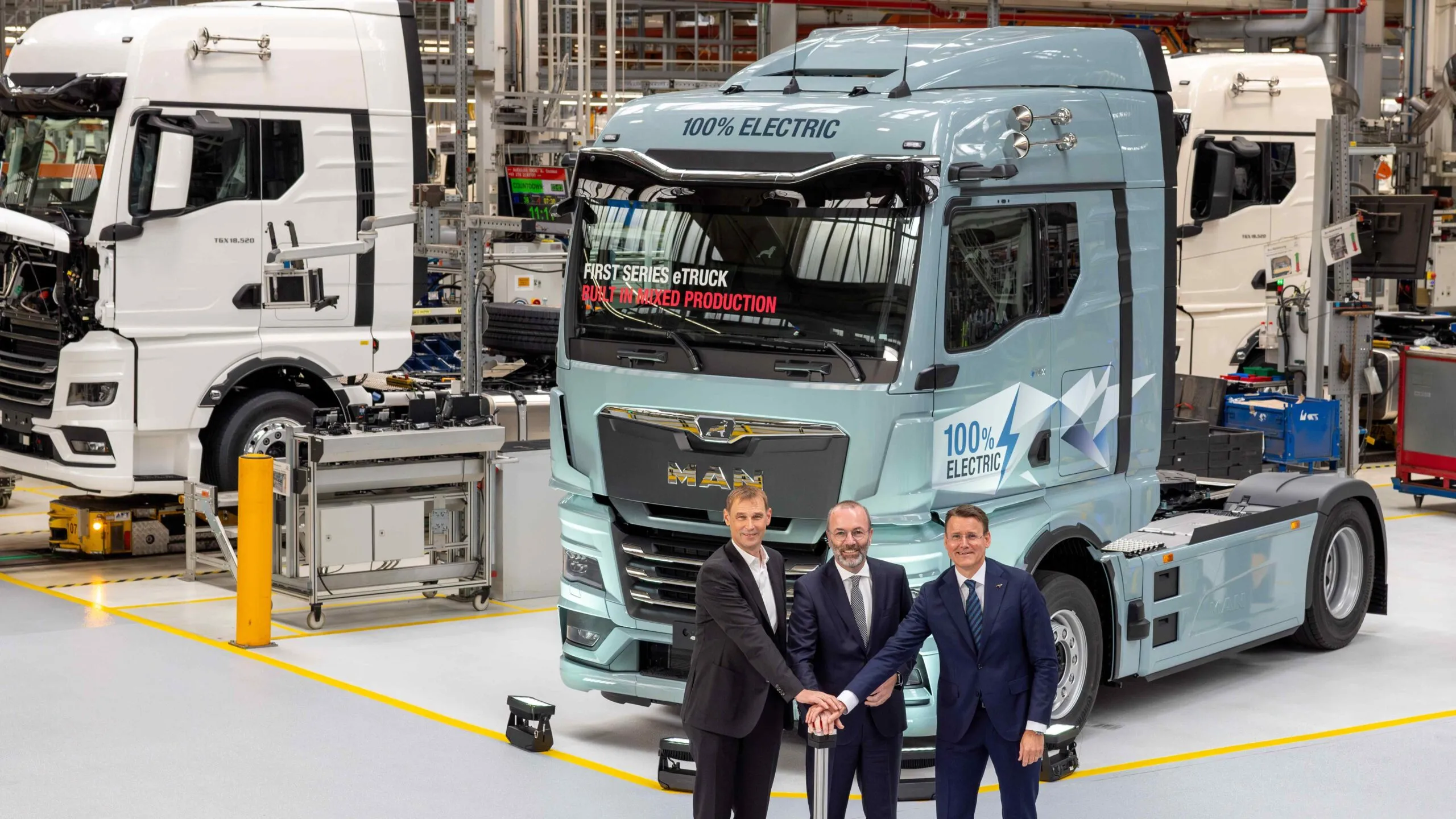 MAN CEO Alexander Vlaskamp, MEP Manfred Weber, and Michael Kobriger launch series production of electric trucks at Munich plant