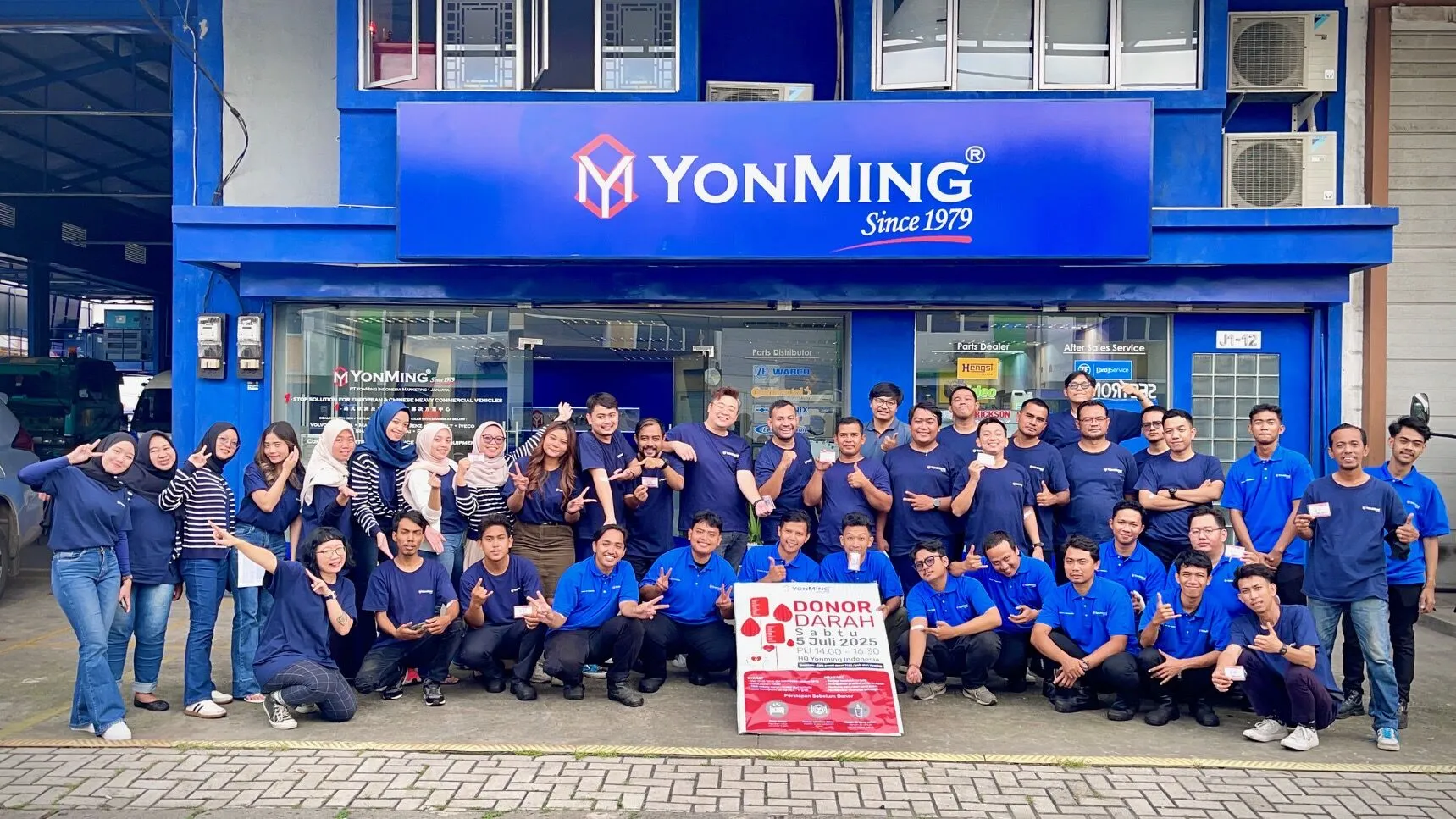 YonMing Indonesia staff pose after July 2025 blood donation drive with RED-B banner