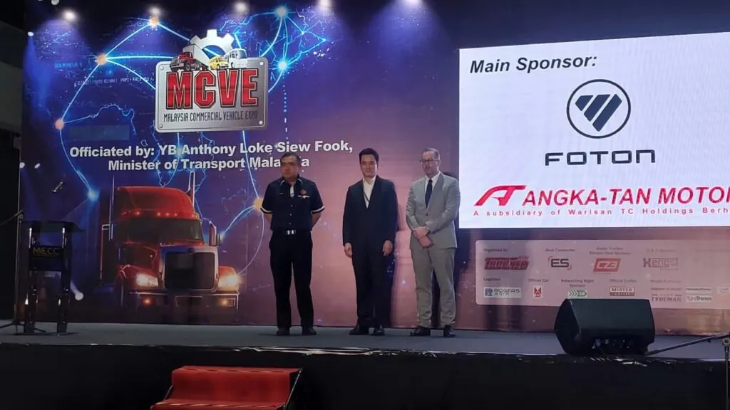Transport Minister Anthony Loke with James Tan and Stefan Pertz at the main stage of MCVE 2026.
